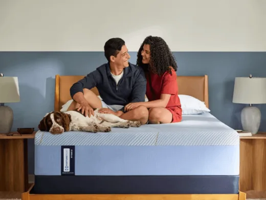 Couple trying a mattress in a Mattress For Less showroom